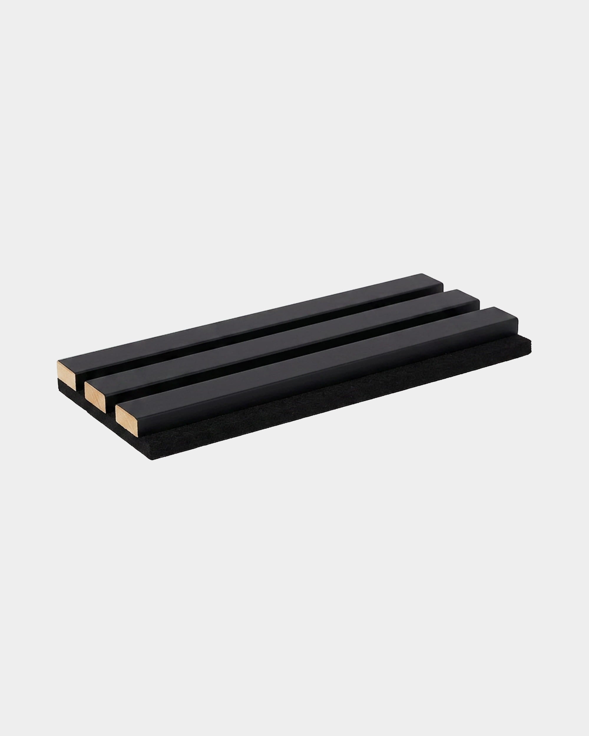Three parallel rectangular black acoustic slats on a base, showing a WoodUpp Akupanel sample in colored black wrap with visible natural wood ends.